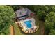 Aerial view of a home featuring a backyard pool, patio, and mature trees at 180 Mountain Path, Rockmart, GA 30153