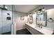 Contemporary bathroom showcases a double sink vanity, shower, and modern lighting fixtures at 180 Mountain Path, Rockmart, GA 30153