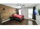 Bedroom boasts hardwood floors, a ceiling fan, wood accent wall and a TV at 180 Mountain Path, Rockmart, GA 30153