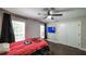 Bedroom featuring hardwood floors, a ceiling fan, two windows, and double door closet at 180 Mountain Path, Rockmart, GA 30153