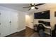 Versatile bedroom featuring hardwood floors, a TV, a ceiling fan, and closet doors at 180 Mountain Path, Rockmart, GA 30153