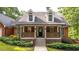 Lovely home showcasing a welcoming front porch, brick facade, and lush landscaping at 180 Mountain Path, Rockmart, GA 30153