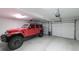 Clean, well-lit garage featuring a red Jeep Wrangler at 180 Mountain Path, Rockmart, GA 30153
