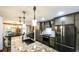 Large island kitchen with granite countertops, stainless steel appliances, and seating at the breakfast bar at 180 Mountain Path, Rockmart, GA 30153