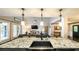 Granite kitchen island with barstool seating, stainless steel sink, and view to an open living room at 180 Mountain Path, Rockmart, GA 30153