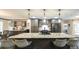 Large kitchen island featuring bar stool seating, granite countertop, stainless steel appliances and ample cabinet space at 180 Mountain Path, Rockmart, GA 30153