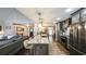 Bright kitchen features stainless steel appliances, granite countertops, and barstool seating at the center island at 180 Mountain Path, Rockmart, GA 30153