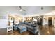 Open-concept living room featuring a large sectional sofa and hardwood floors next to an island kitchen at 180 Mountain Path, Rockmart, GA 30153