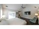 Bedroom with a ceiling fan, television, large windows, and an upholstered chair at 180 Mountain Path, Rockmart, GA 30153