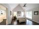 Vaulted main bedroom features a ceiling fan, hardwood floors, and ensuite bathroom at 180 Mountain Path, Rockmart, GA 30153