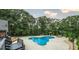 Private backyard oasis with a freeform pool, lush landscaping, and lounge chairs at 180 Mountain Path, Rockmart, GA 30153