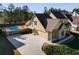 Side view of a home with a private pool, large driveway, two car garage and manicured lawn at 2006 Hubbard Ct, Villa Rica, GA 30180