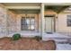 Covered brick front porch and entrance with bushes and pine needles at 2006 Hubbard Ct, Villa Rica, GA 30180