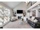 Bright living room features hardwood floors, built-in bookshelves, and a comfortable leather sofa at 2006 Hubbard Ct, Villa Rica, GA 30180