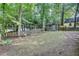 Private backyard surrounded by lush greenery, mature trees and a classic wood fence for peaceful outdoor enjoyment at 235 Trailmore Ct, Roswell, GA 30076