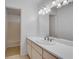 Bathroom features a large mirror, a light countertop, and a view of the shower area at 235 Trailmore Ct, Roswell, GA 30076