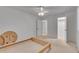 Bedroom with closet access, neutral carpet, and a ceiling fan for a comfortable space at 235 Trailmore Ct, Roswell, GA 30076