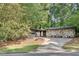 Attractive exterior view of a modern home with stone accents, a gray garage door, and a spacious driveway at 235 Trailmore Ct, Roswell, GA 30076
