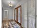 Entryway with decorative double doors, checkered tile, and white walls at 235 Trailmore Ct, Roswell, GA 30076