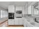 Corner view of efficient kitchen with white cabinetry and black appliances at 235 Trailmore Ct, Roswell, GA 30076