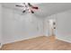 Open, airy living room with light wood flooring, ceiling fan, and neutral paint at 235 Trailmore Ct, Roswell, GA 30076