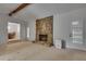 A spacious living room features a stone fireplace and ample light at 235 Trailmore Ct, Roswell, GA 30076