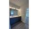 Bathroom featuring a double vanity with sleek cabinets and modern lighting fixtures at 3030 Fairway Dr, Villa Rica, GA 30180