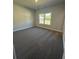 Spacious bedroom with a window and neutral carpeting at 3030 Fairway Dr, Villa Rica, GA 30180