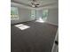 Spacious main bedroom featuring a tray ceiling, ceiling fan and large windows for abundant natural light at 3030 Fairway Dr, Villa Rica, GA 30180