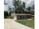 Traditional two-story home with a long driveway leading to a two car garage at 3030 Fairway Dr, Villa Rica, GA 30180