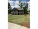 Traditional two-story home with a well-manicured lawn, dark shutters and gray brick at 3030 Fairway Dr, Villa Rica, GA 30180