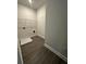 Laundry room with wood-look flooring and overhead wire shelving at 3030 Fairway Dr, Villa Rica, GA 30180