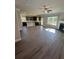 Open-concept living room featuring a fireplace, ceiling fan and large windows for an airy feel at 3030 Fairway Dr, Villa Rica, GA 30180