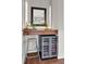 This bar area features a wine refrigerator, a floating wood shelf, and a mirrored backsplash at 201 Beacon Cv, Canton, GA 30114