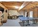 Partially finished basement with a recreation area featuring a ping pong table and ample space at 201 Beacon Cv, Canton, GA 30114