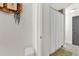 Hallway view into a bathroom with a shower with a white curtain and decorations at 201 Beacon Cv, Canton, GA 30114