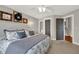 Bedroom featuring carpeted floors, ceiling fan, and a view into the bathroom at 201 Beacon Cv, Canton, GA 30114
