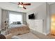 Cozy bedroom with a decorative ceiling fan, natural light and a reading chair at 201 Beacon Cv, Canton, GA 30114