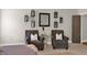 Bedroom with seating area, decorated with wall lanterns and neutral colors at 201 Beacon Cv, Canton, GA 30114