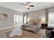 Large bedroom with sitting area featuring a large window and carpeted floors at 201 Beacon Cv, Canton, GA 30114