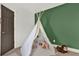 bedroom teepee decor, monkey stuffed animal, green wall and door to hall at 201 Beacon Cv, Canton, GA 30114