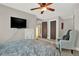 Bedroom featuring a decorative ceiling fan, television, a reading chair and natural light at 201 Beacon Cv, Canton, GA 30114