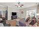 Spacious bedroom featuring a ceiling fan, large TV, sitting area and adjoining office space at 201 Beacon Cv, Canton, GA 30114