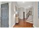 Elegant foyer with wood floors, staircase, statement mirror, and stylish furniture at 201 Beacon Cv, Canton, GA 30114