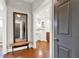 Entry foyer with hardwood floors, bench seat, and large mirror at 201 Beacon Cv, Canton, GA 30114