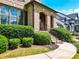 Inviting front entrance with arched brick details, lush landscaping, and well-maintained walkway at 201 Beacon Cv, Canton, GA 30114