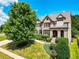 Charming two-story home with manicured lawn, lush landscaping, and classic architectural details at 201 Beacon Cv, Canton, GA 30114