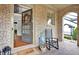Welcoming front porch with brick flooring, arched entryways, and a comfortable rocking chair at 201 Beacon Cv, Canton, GA 30114