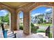 Relaxing front porch with brick arches offering scenic views of the neighborhood and lush greenery at 201 Beacon Cv, Canton, GA 30114