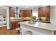 This spacious kitchen features dark wood cabinets, a light countertop, and an island with stool seating at 201 Beacon Cv, Canton, GA 30114